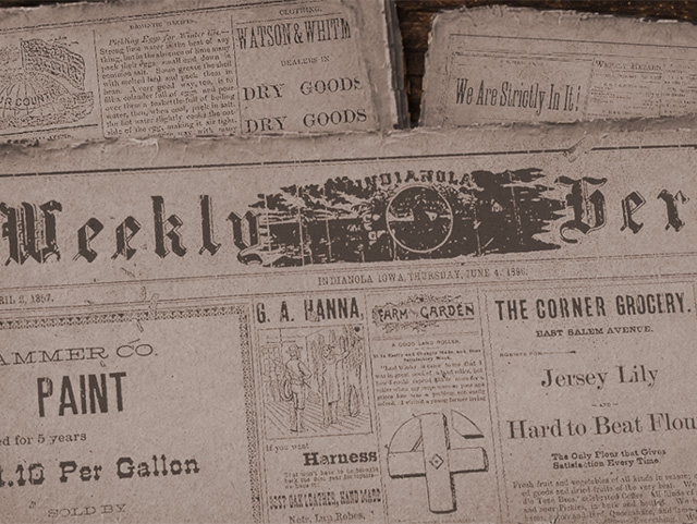 Close-up of vintage newspapers including the Weekly Indianola Herald from June 4, 1896, and local advertisements
